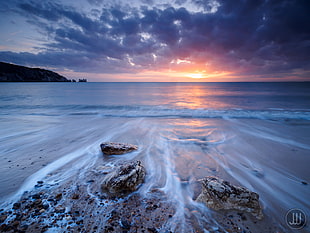 photography of body of water during sunrise