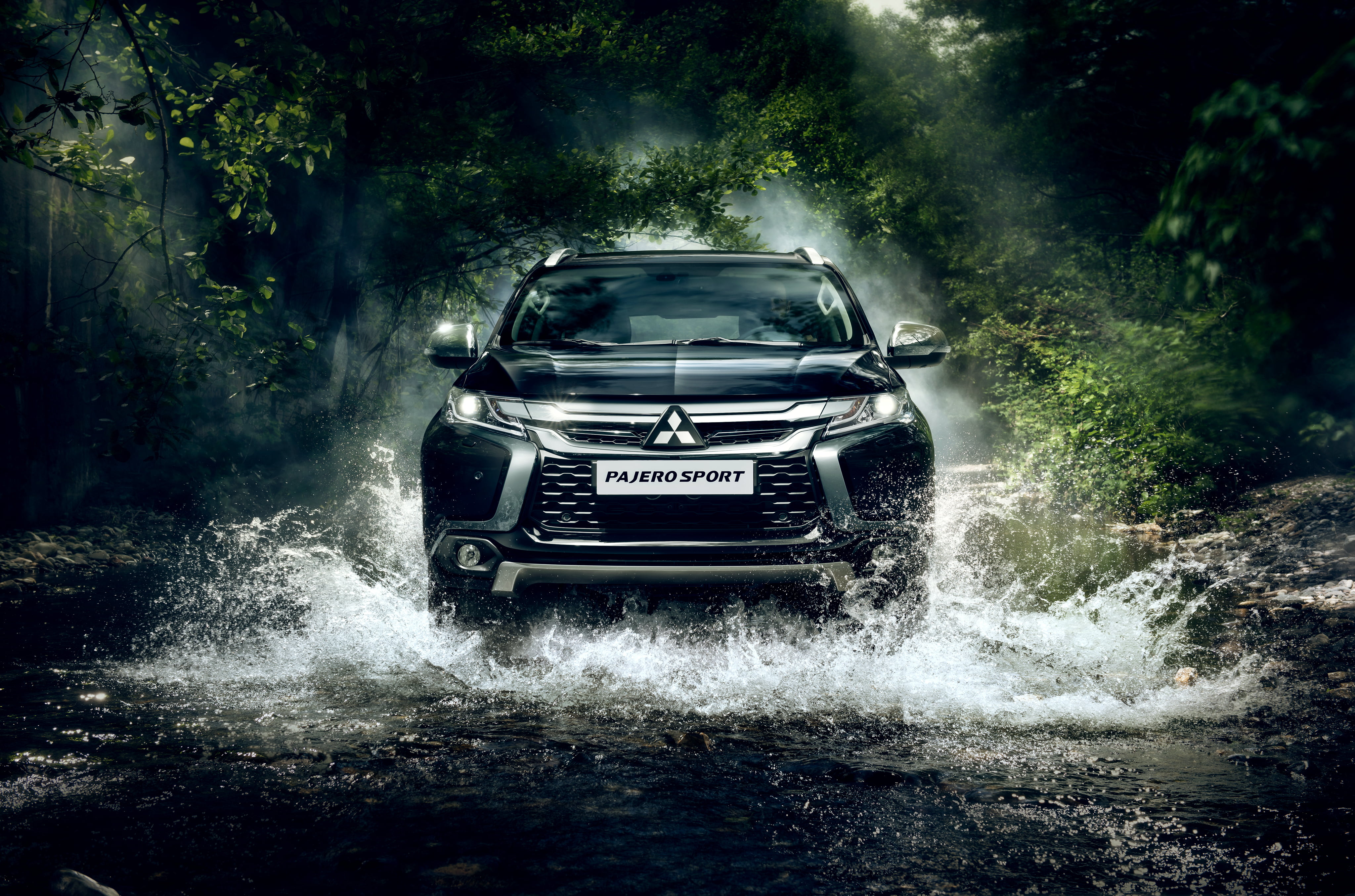 Premium Photo | A mitsubishi pajero is driving through a forest.