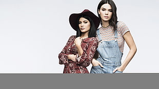 woman in blue denim overalls beside the woman in brown dress