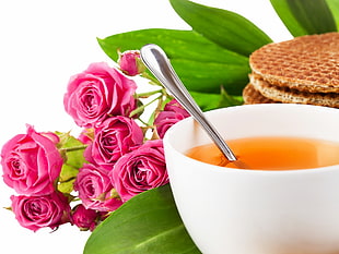 close up photography of cup of tea near bouquet of pink roses HD wallpaper