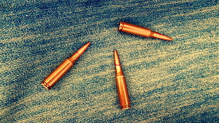 three brass bullets HD wallpaper