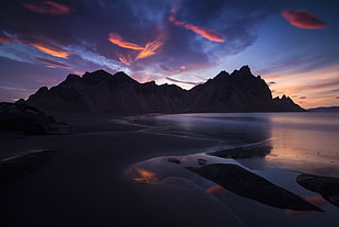 seashore and black rock formations, Iceland, mountains, landscape, clouds HD wallpaper