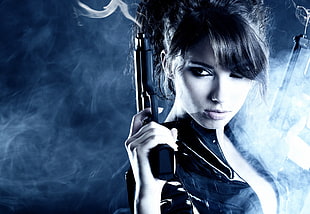 woman wearing black top holding black pistol