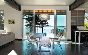 dining set with clear glass door and body of water in background HD wallpaper