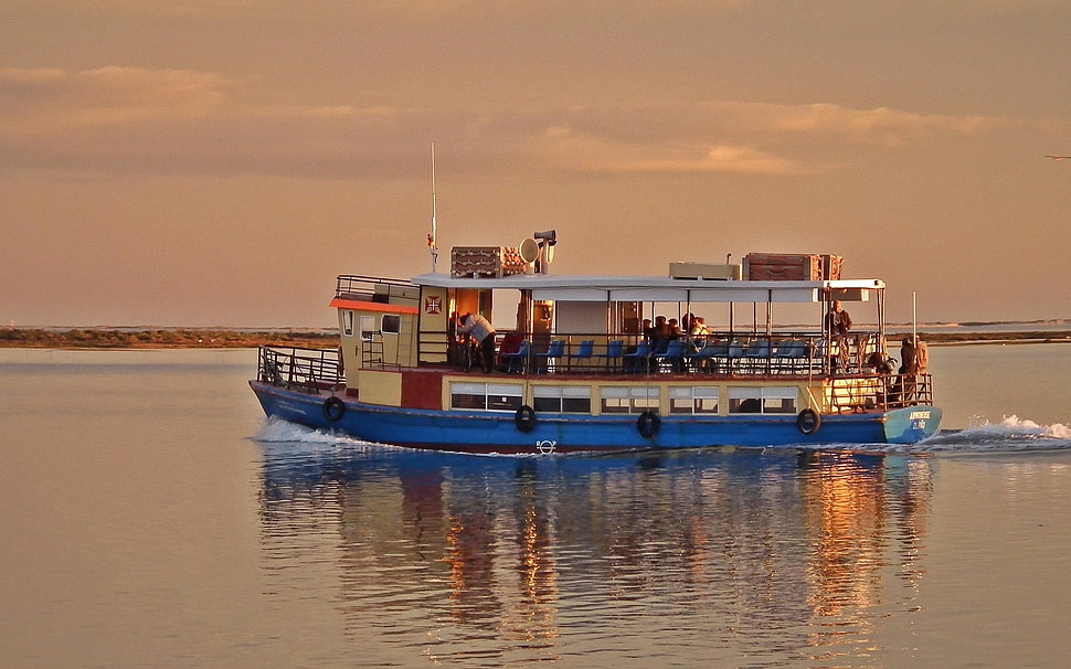 white and blue boat on ocean during sunset HD wallpaper