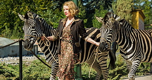 woman wearing blazer holding two zebras HD wallpaper