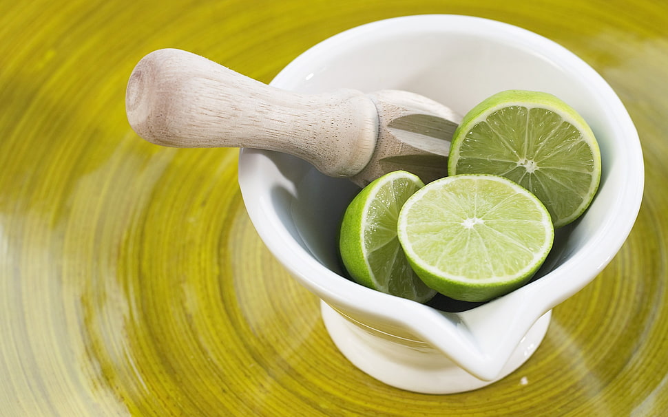 white and brown mortar and pestle with sliced lemons HD wallpaper