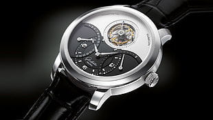 round silver skeleton watch with black leather strap