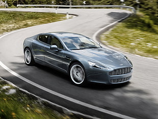 time lapse photography of Aston Martin coupe hitting road during daytime HD wallpaper