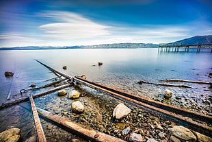 black metal bar lot on top of rocks beside body of water, lake tahoe, california HD wallpaper