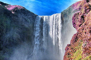 waterfalls under blue sky at daytime, iceland