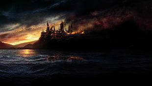 burning castle near body of water and mountain HD wallpaper