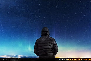 man wearing black hoodie watching aurora borealis HD wallpaper