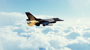 black and yellow jet plane above white clouds HD wallpaper