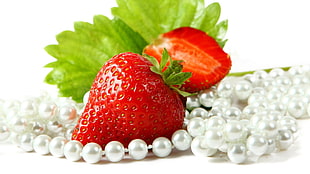 strawberry beside of white beaded necklac HD wallpaper