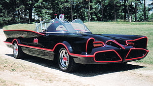 classic black and red convertible on gray soil