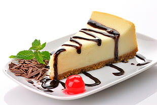 slice of cake with chocolate syrup on white ceramic plate