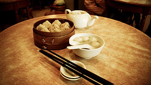 dumplings on brown wooden steamer