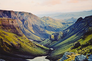 green mountains under orange cloudy sky during daytime