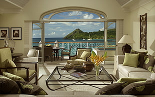 brown wooden table set on balcony with overlooking view of sea