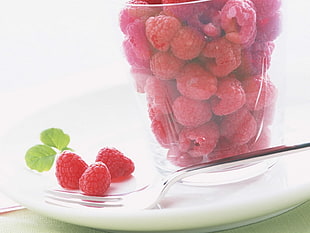 Raspberries on spoon and in clear glass container HD wallpaper