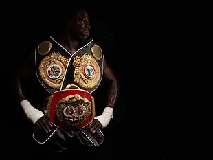 person with two black and red World championship belts HD wallpaper