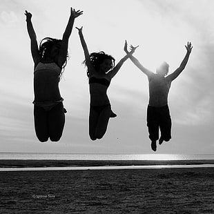 silhouette of three person jumping under cloudy sky during daytime HD wallpaper