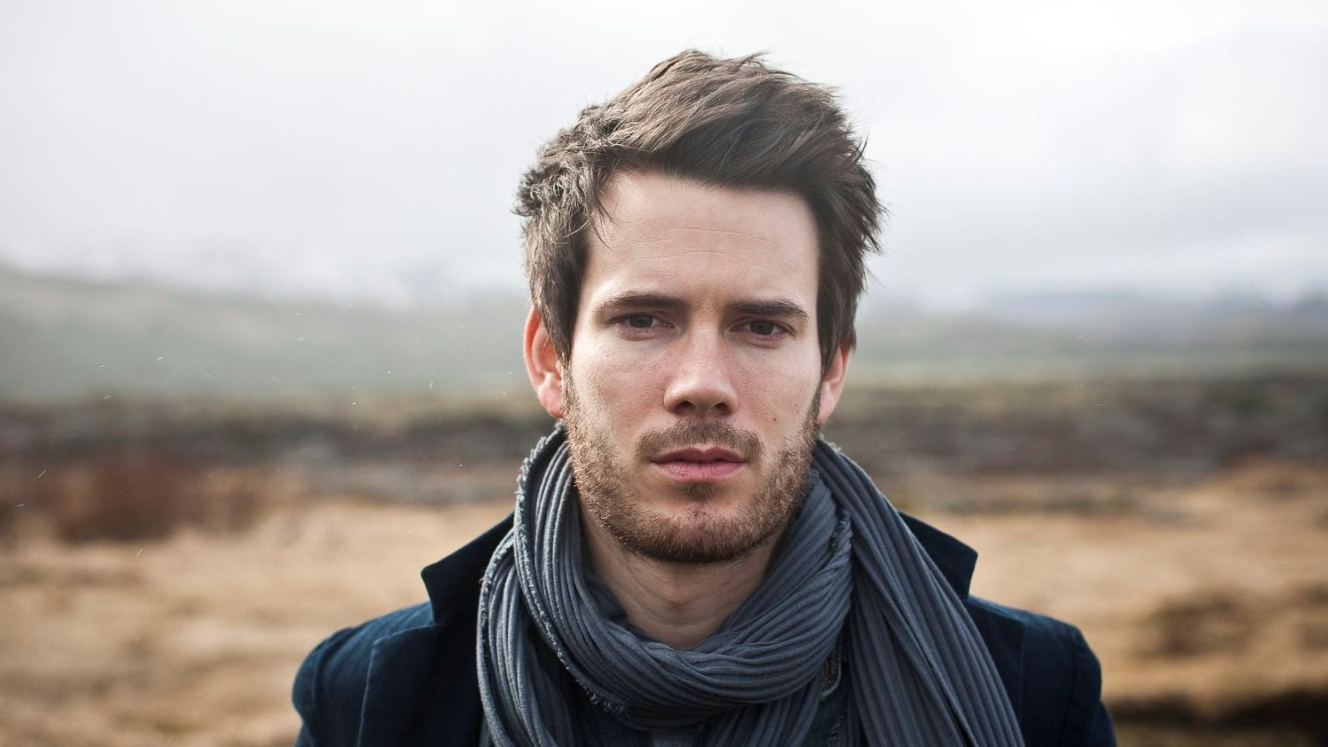 man wearing gray scarf during daytime