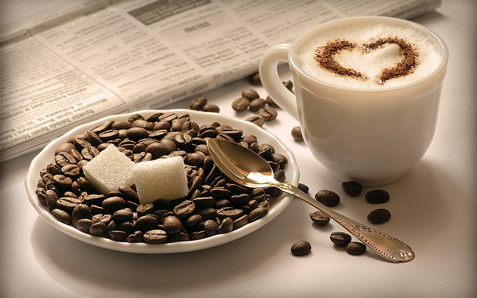 selective focus photograph of white ceramic mug, coffee beans, sugar cubes, and stainless steel spoon