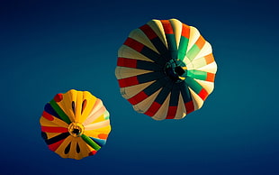 two orange and blue ribbon decors, hot air balloons, sky, worm's eye view