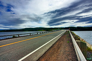 concrete road near sea during daytime HD wallpaper