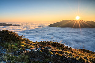 three mountains and clouds landmark during golden hour HD wallpaper