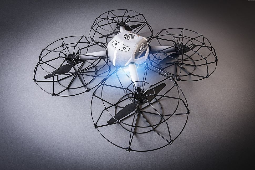 turned on white and black quadcopter drone on gray platform HD wallpaper