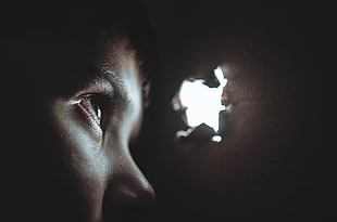 boy peeping through hole