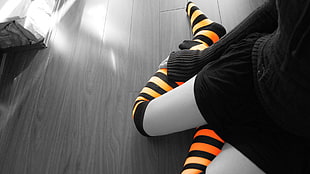 person wearing orange and black striped socks HD wallpaper