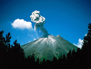 mountain with smoke and clouds