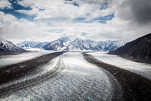 snow terrain under cloudy blue sky