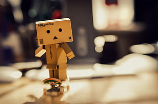 selective focus photo of cardboard box character on skateboard HD wallpaper