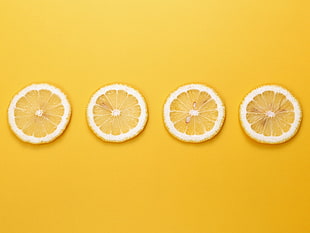 four slices of citrus fruit, yellow background, fruit, lemons, minimalism HD wallpaper