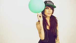 woman in black top holding green balloon HD wallpaper