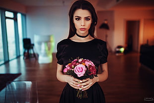 woman wears black scoop-neck dress holding pink flowers HD wallpaper