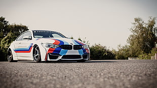 close up photograph of white, red, and blue BMW coupe