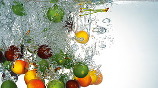 green and orange fruits washed by water HD wallpaper