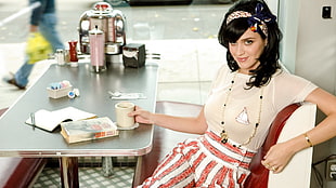 Katy Perry sitting on a bench HD wallpaper