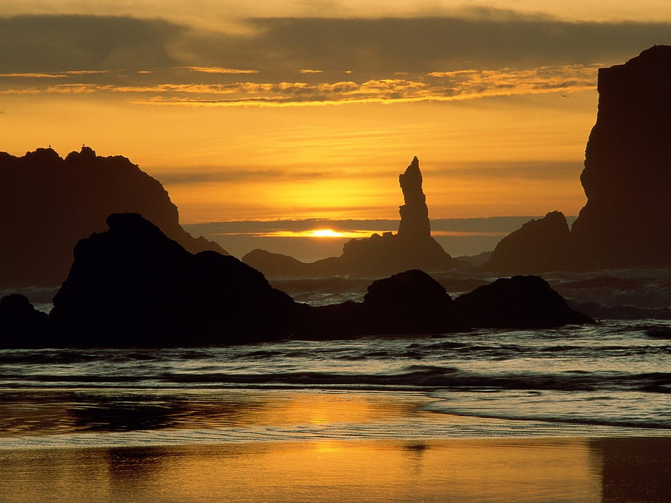 silhouette of rock formations at golden hour HD wallpaper