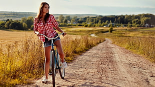 woman riding bike on road during daytime