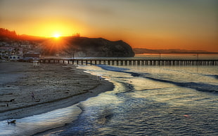 village beside mountain, bridge and seashore over the horizon