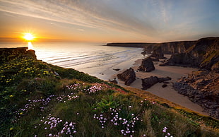 landscape photo of rock island near beach