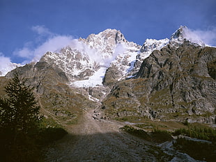 gray and green mountain during with fog during daytime