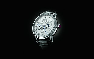 photo of silver chronograph watch on dim light